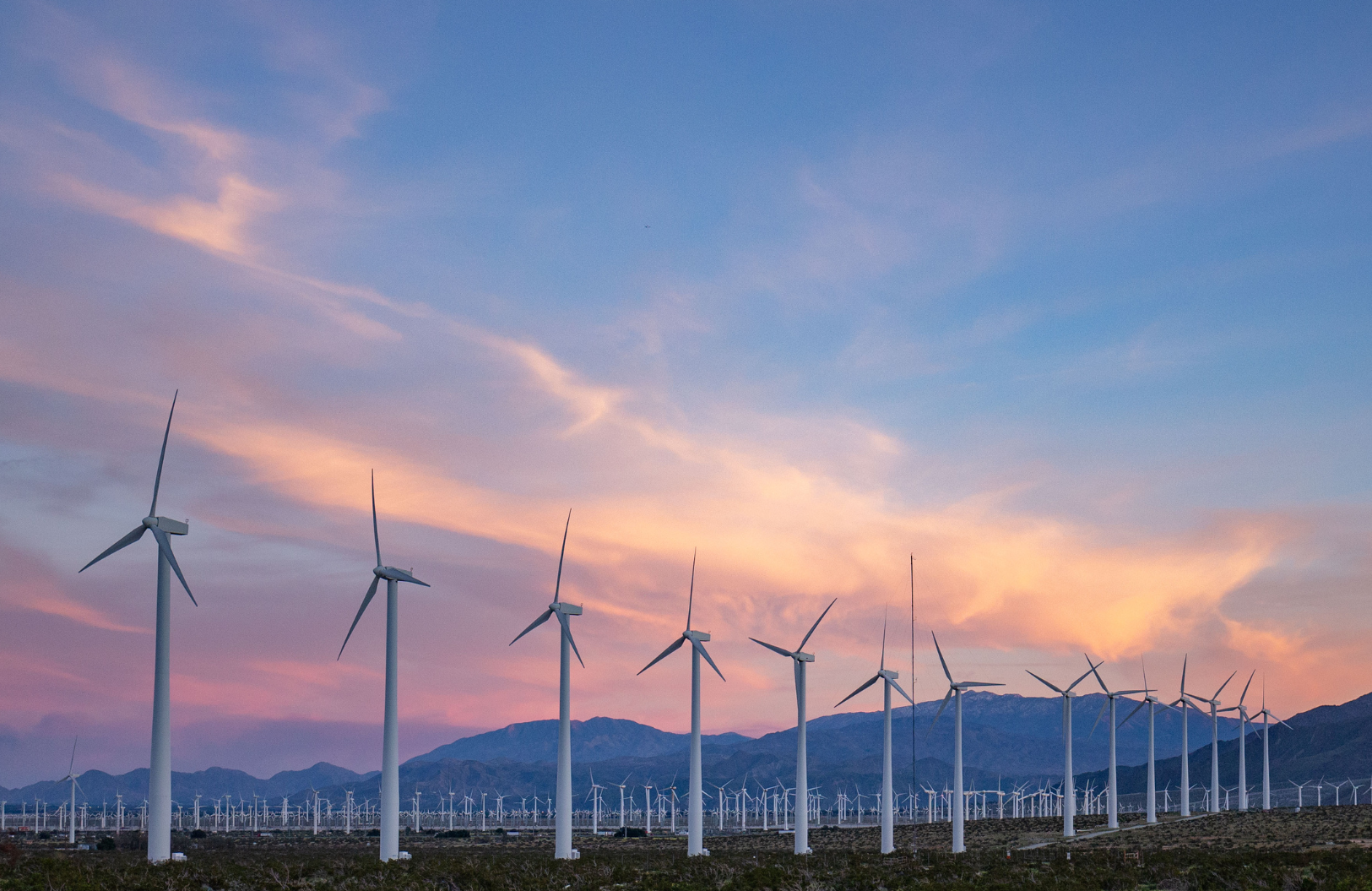 wind turbines with sunset in the background